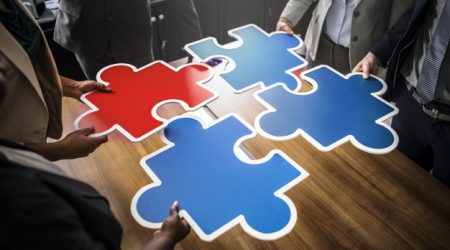 Business people connecting puzzle pieces