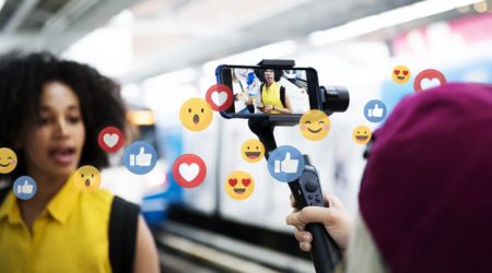 Vlogger streaming a live video live at a train platform