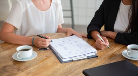 young-female-colleagues-meeting-discussing-business-plan-writing-strategy-scheme-paper-making-draft_74855-10467